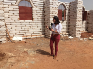 Kerry Alexander next to school made of moon bricks in Senegal